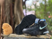 Black basketball shoe shown beside its patterned outsole.