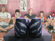 Rear view of dark blue basketball sneakers showing textured heel panels and lavender collar details.