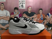 Side view of a white and black Nike basketball sneaker showing the Swoosh, patterned side detail, and speckled midsole.