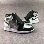 Pair of high-top sneakers displayed together, highlighting the contrasting black, white, and metallic silver color blocking.