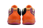 Rear view of the orange Jordan sneakers showing pink patterned side panels and heel branding.