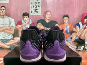 Rear view of the black and purple Nike basketball sneakers, showing the heel panels and textured detailing.