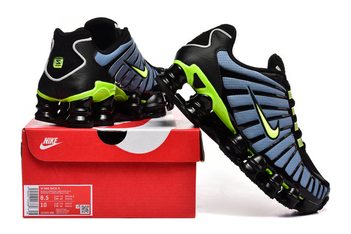 Nike Shox TL sneakers in black, blue, and volt displayed with a Nike shoe box; the box label shows the model and size details.