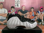 Side profile of a white and black sneaker showing the sculpted white sidewall and black outsole section.