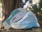 Pair of sneakers showing the patterned outsole and side profile with blue midsole detailing.