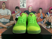 Front view of bright green low-top basketball shoes with matching laces