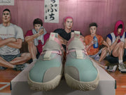 Front view of pink and light grey Adidas sneakers showing textured uppers, tongue pull tabs and contrasting toe panels.