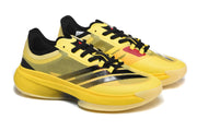 Pair of yellow and black basketball shoes shown at an angled front-side view