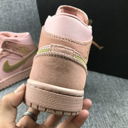 Close-up of the heel showing pink and suede-textured panels with a visible olive-green accent.