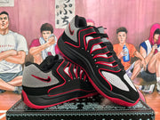 Angled view of a pair of black, white, and red Nike basketball sneakers displayed on a patterned box.
