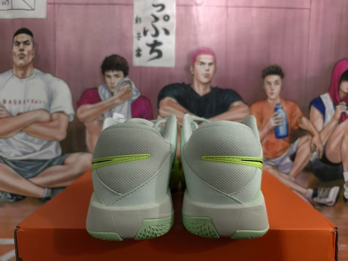 Rear view of gray-green Nike basketball shoes with bright green heel accents