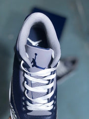 Close-up of the sneaker tongue with a Jumpman emblem, grey collar, and white laces.