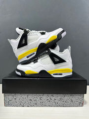 Pair of white, yellow, and black Jordan Air Jordan 4 sneakers shown from angled side views on a shoebox.