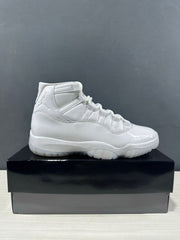 Side profile of a white high-top sneaker with a glossy toe area and sculpted sole.