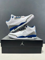 Two white and blue Air Jordan 3 sneakers displayed from opposite side angles with elephant-print panels visible.
