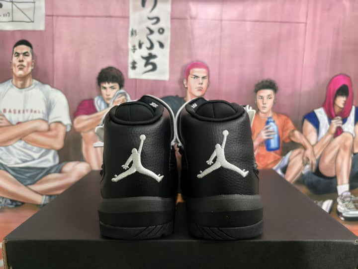 Rear view of black Jordan high-top sneakers with white Jumpman logos and padded collars.