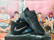 Pair of black low-top Nike basketball shoes with silver Swoosh accents and textured uppers.