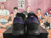 Rear view of the pair showing purple heel panels, black uppers, and Kobe emblems.