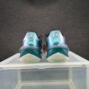 Rear view of the shoes showing GT heel emblems and aqua-blue heel panels