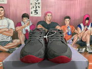 Front view of grey and red Nike basketball sneakers showing the lace-up closure, textured toe boxes and red rubber forefoot.