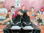 Front view of black Jordan basketball shoes with white and red details