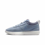 Muted blue low-top sneaker with tonal side swoosh, matching laces, and white outsole.