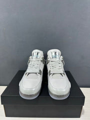 Front view of the grey Jordan Air Jordan 4 pair showing the woven laces, mesh tongues and rounded toe boxes.