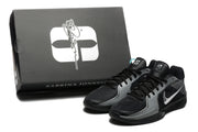 Black and grey basketball shoes displayed with a box marked Sabrina Jones.