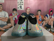Front view of silver holographic basketball shoes with black laces and turquoise outsoles