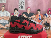 Side view of a red and black Nike sneaker with wavy panels and black Swoosh