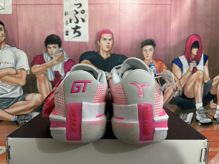 Rear view of gray and pink Nike GT basketball shoes