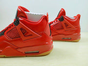 Close side view showing the red upper, side mesh panel, molded support, and visible midsole air unit.