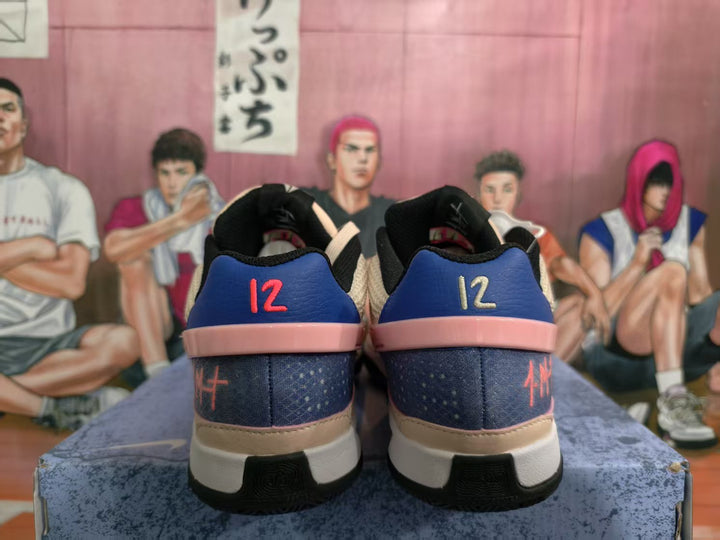 Rear view of pink and purple Nike low-top sneakers showing blue heel panels, contrasting heel graphics, and layered soles.