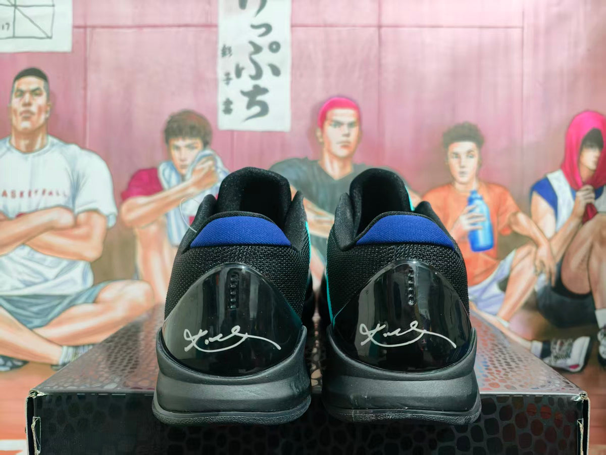 Rear view of black and turquoise basketball sneakers with blue heel accents