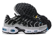 Side view of black and grey Nike Air Max Plus sneakers showing the treaded outsole and blue-tinted sole details