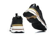Rear and outsole views of the sneakers, showing tan heel accents and raised heel lettering.