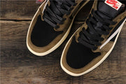 Close view of the black perforated toe boxes, brown overlays, and black laces.