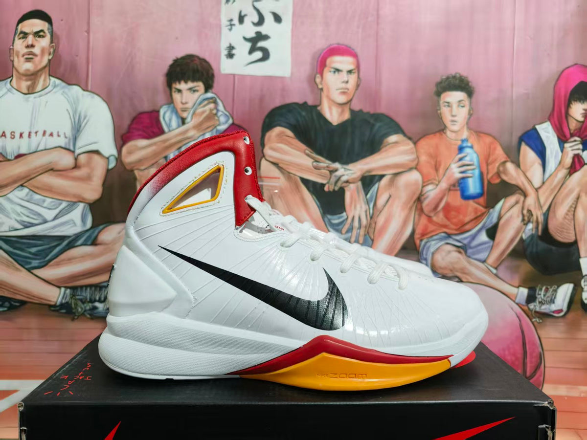 Side view of a white Nike high-top basketball shoe with black side logo, red collar, yellow accents, and Zoom branding on the outsole.