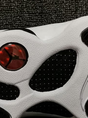 Close-up of the white outsole with black sections and a red circular heel detail