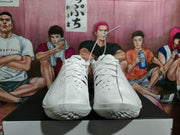 Front view of white lace-up basketball sneakers showing perforated forefoot panels, black Swoosh details, and treaded outsoles.