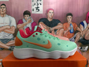 Side profile of a mint Nike sneaker with an orange swoosh, red accents, and a white ribbed outsole.