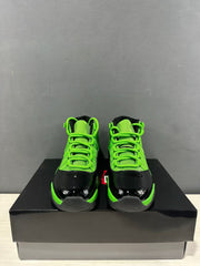 Front view of the pair showing green laces and tongues with glossy black toe panels.