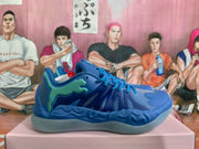 Side profile of a blue Puma sneaker showing the mint-green side branding, textured panels and sculpted sole.