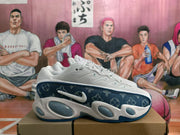 Side view of a white and navy Nike sneaker showing the swoosh, patterned navy side panel, mesh upper, and rounded midsole details.