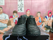Front view of black Nike LeBron shoes with textured uppers and black laces