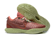 Side view of the sneaker with the Nike swoosh, patterned upper, speckled green midsole, and textured outsole.