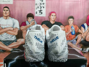 Rear view showing blue heel branding, gray patterned details, and the textured outsole.