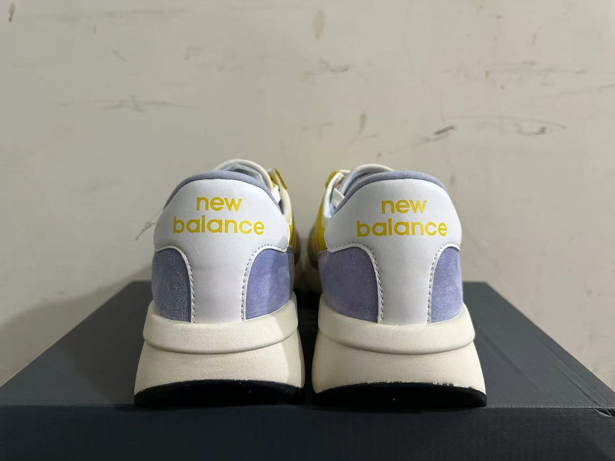 Rear view of yellow, white, and lavender New Balance U370 sneakers