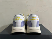 Rear view of yellow, white, and lavender New Balance U370 sneakers