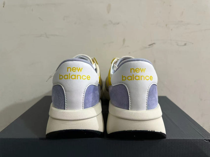 Rear view of yellow, white, and lavender New Balance U370 sneakers